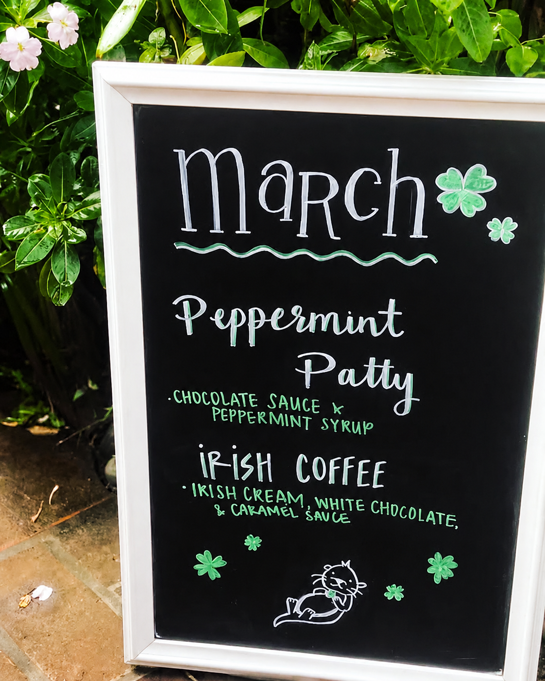 Historical seasonal chalkboard lettering surrounded by greenery